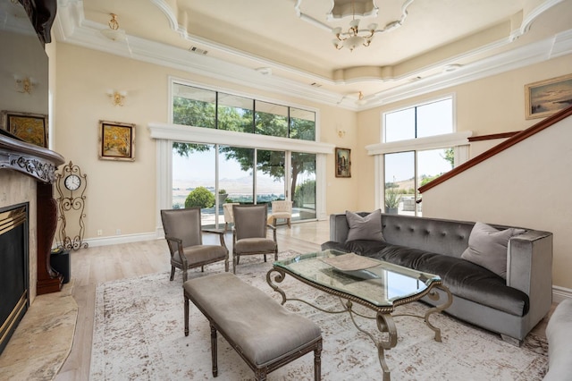 14215 Killarney Dr, Madera, CA 93636 - living area featuring a chandelier, ornamental molding, a tray ceiling, a premium fireplace, and a towering ceiling