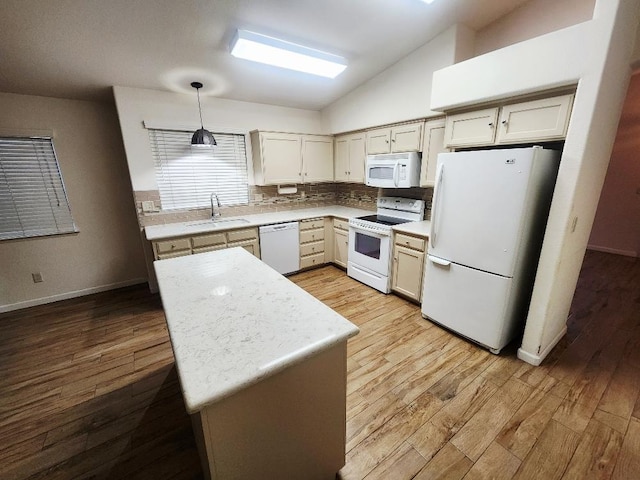 4686 W Sierra Ave, Fresno, CA 93722 - kitchen featuring white appliances, a sink, light countertops, light wood-style flooring, and lofted ceiling