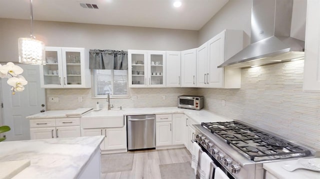 32003 Shah Ct, Coarsegold, CA 93614 - kitchen featuring wall chimney exhaust hood, stainless steel appliances, a sink, white cabinets, and recessed lighting