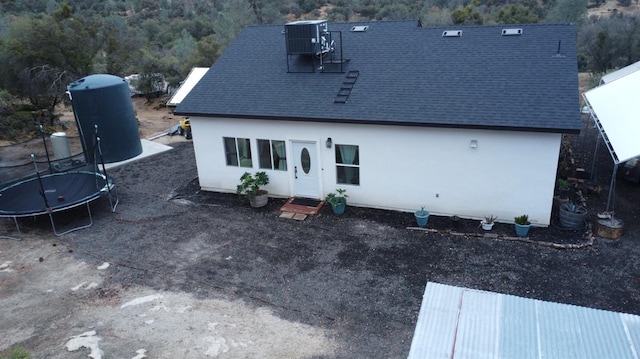 32003 Shah Ct, Coarsegold, CA 93614 - rear view of house with a trampoline, roof with shingles, and central AC unit
