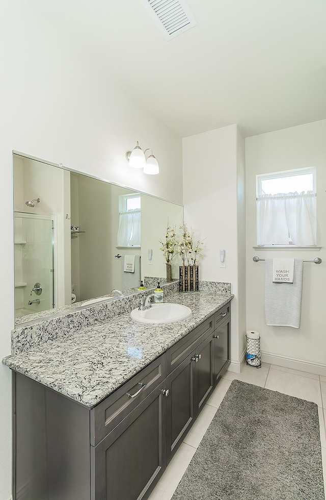 1523 N Ryan Ave, Clovis, CA 93619 - full bath featuring tile patterned flooring, vanity, a shower with door, baseboards, and toilet