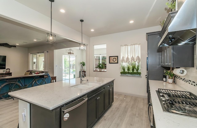1523 N Ryan Ave, Clovis, CA 93619 - kitchen featuring stainless steel appliances, range hood, a sink, light wood finished floors, and open floor plan