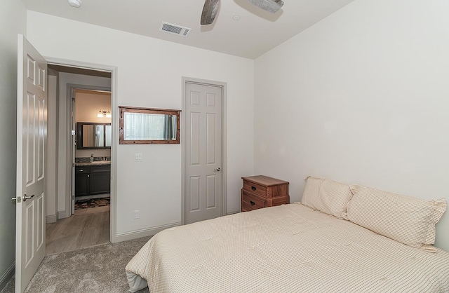 1523 N Ryan Ave, Clovis, CA 93619 - bedroom featuring carpet flooring, a sink, ensuite bath, wood finished floors, and baseboards
