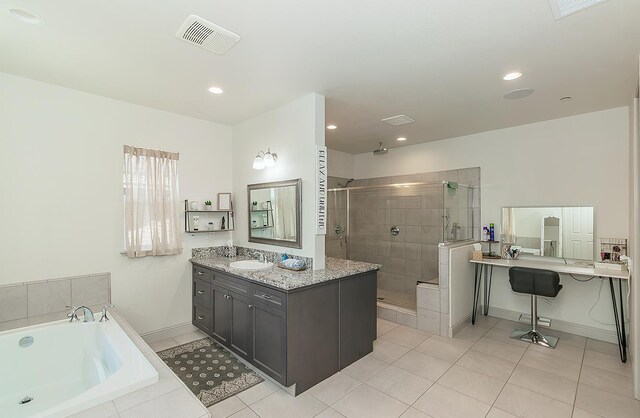 1523 N Ryan Ave, Clovis, CA 93619 - full bathroom with a shower stall, a garden tub, vanity, tile patterned flooring, and baseboards