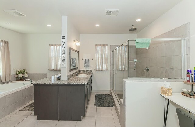1523 N Ryan Ave, Clovis, CA 93619 - full bathroom featuring tile patterned flooring, a shower stall, a garden tub, vanity, and recessed lighting