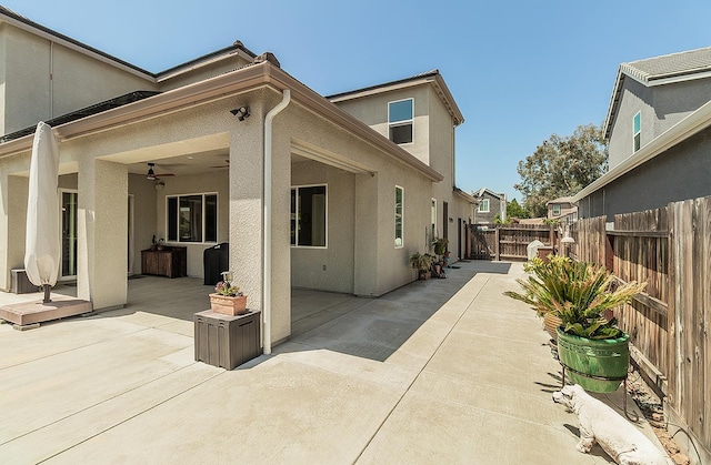 1523 N Ryan Ave, Clovis, CA 93619 - view of side of home with stucco siding, ceiling fan, a patio area, and a gate