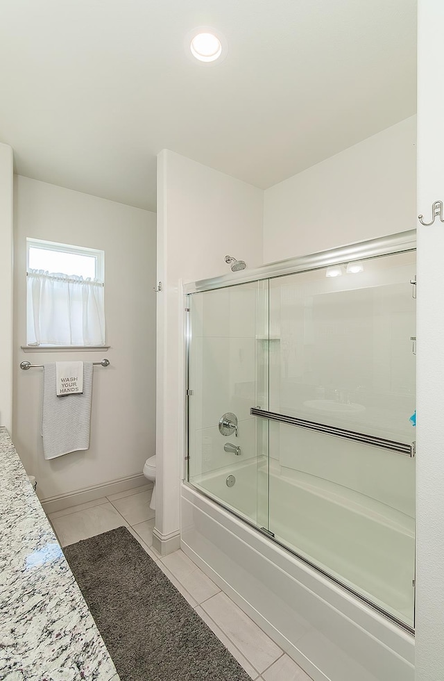 1523 N Ryan Ave, Clovis, CA 93619 - bathroom featuring tile patterned flooring, toilet, shower / bath combination with glass door, and baseboards