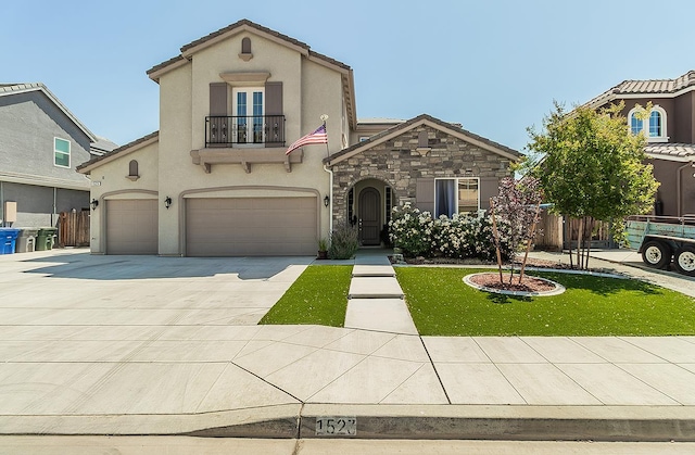 1523 N Ryan Ave, Clovis, CA 93619 - mediterranean / spanish house with a balcony, an attached garage, stucco siding, concrete driveway, and stone siding