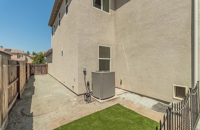 1523 N Ryan Ave, Clovis, CA 93619 - view of property exterior featuring stucco siding, central AC, and a fenced backyard