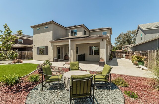 1523 N Ryan Ave, Clovis, CA 93619 - back of property with stucco siding, a patio area, and a fenced backyard