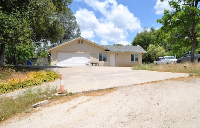 43379 Leach Rd, Ahwahnee, CA 93601 - single story home featuring concrete driveway, stucco siding, and a garage