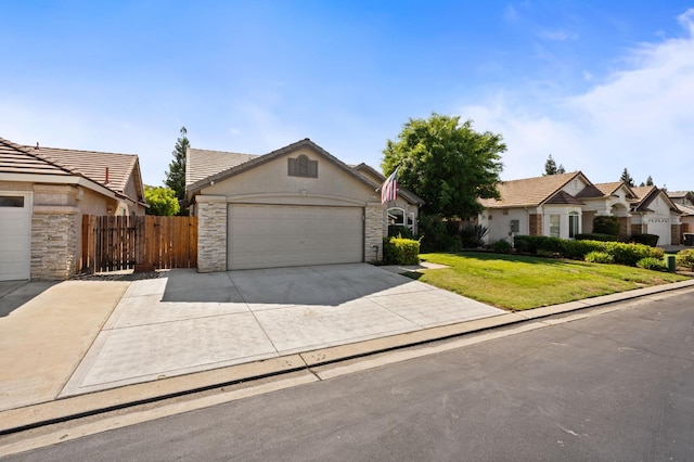 8574 N Heartland Way, Fresno, CA 93720 - view of front of property featuring stone siding, concrete driveway, a garage, and stucco siding