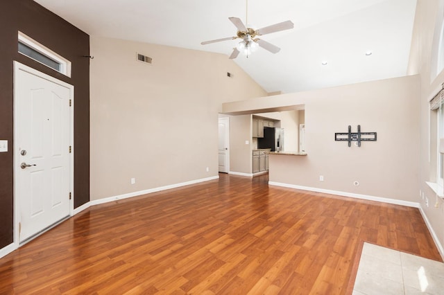 8574 N Heartland Way, Fresno, CA 93720 - unfurnished living room with high vaulted ceiling, a ceiling fan, light wood-type flooring, and baseboards