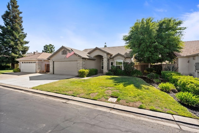 8574 N Heartland Way, Fresno, CA 93720 - ranch-style home featuring a garage, stone siding, stucco siding, concrete driveway, and a tile roof