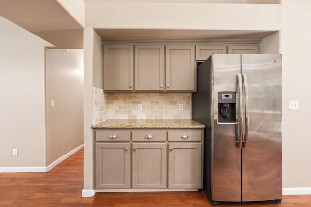 8574 N Heartland Way, Fresno, CA 93720 - kitchen with stainless steel fridge, gray cabinetry, baseboards, decorative backsplash, and wood finished floors