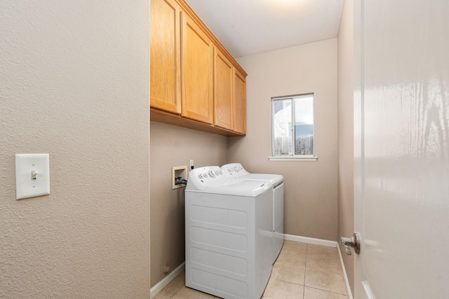 8574 N Heartland Way, Fresno, CA 93720 - washroom with washer and dryer, cabinet space, light tile patterned flooring, and baseboards
