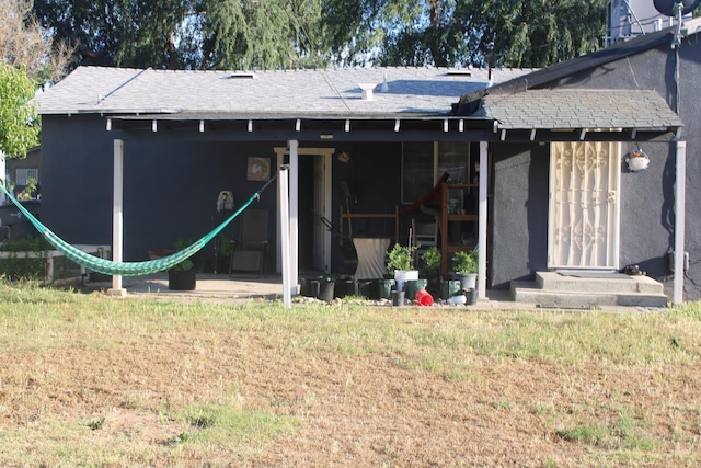 4657 E Hamilton Ave, Fresno, CA 93702 - rear view of house with a shingled roof and stucco siding