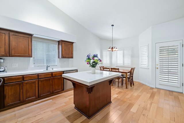 2871 E Ryan Ln, Fresno, CA 93720 - kitchen with dishwasher, a chandelier, light wood finished floors, decorative light fixtures, and tasteful backsplash