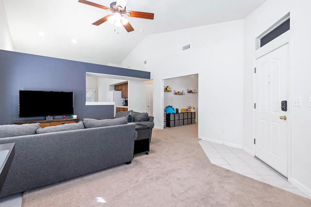 2871 E Ryan Ln, Fresno, CA 93720 - living room featuring light carpet, ceiling fan, high vaulted ceiling, baseboards, and light tile patterned flooring