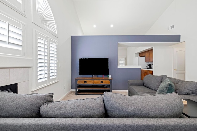 2871 E Ryan Ln, Fresno, CA 93720 - living room with high vaulted ceiling, light colored carpet, baseboards, a fireplace, and recessed lighting