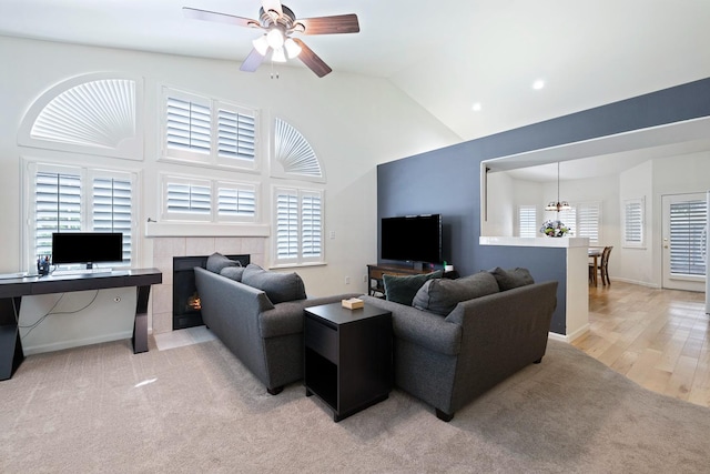 2871 E Ryan Ln, Fresno, CA 93720 - living area featuring ceiling fan, a tiled fireplace, and high vaulted ceiling