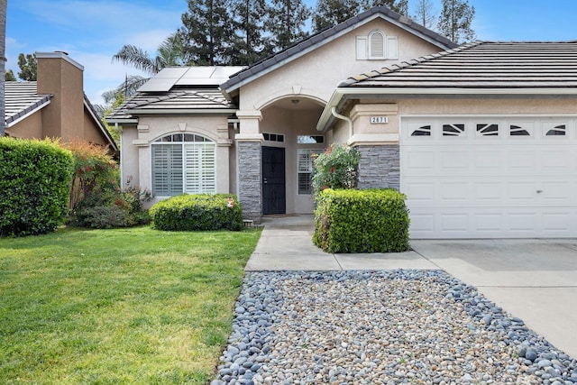 2871 E Ryan Ln, Fresno, CA 93720 - view of front facade featuring stucco siding, a front yard, solar panels, a garage, and driveway