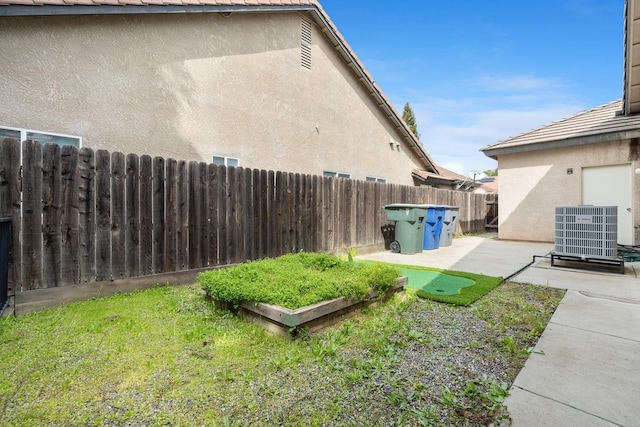 2871 E Ryan Ln, Fresno, CA 93720 - fenced backyard featuring central AC unit and a patio