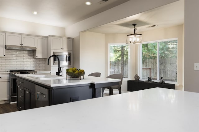 2176 E Pinehurst Ave, Fresno, CA 93730 - kitchen featuring appliances with stainless steel finishes, a sink, light countertops, backsplash, and recessed lighting
