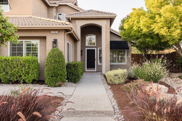 2176 E Pinehurst Ave, Fresno, CA 93730 - view of exterior entry featuring stucco siding and a tiled roof