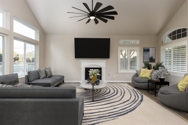 2176 E Pinehurst Ave, Fresno, CA 93730 - living area featuring a fireplace, high vaulted ceiling, baseboards, and a ceiling fan