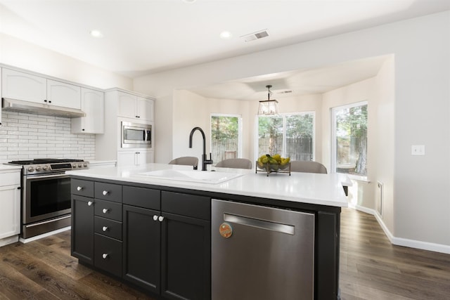 2176 E Pinehurst Ave, Fresno, CA 93730 - kitchen with stainless steel appliances, white cabinetry, a sink, light countertops, and recessed lighting