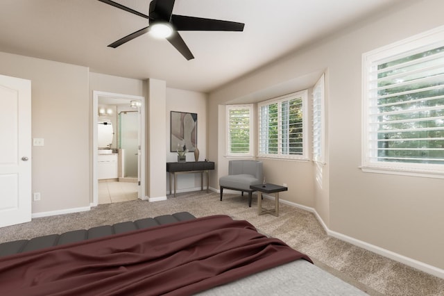 2176 E Pinehurst Ave, Fresno, CA 93730 - carpeted bedroom featuring baseboards, ensuite bathroom, and ceiling fan