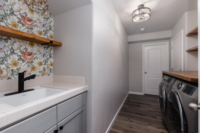 2176 E Pinehurst Ave, Fresno, CA 93730 - laundry area with separate washer and dryer, baseboards, dark wood-style flooring, and cabinet space
