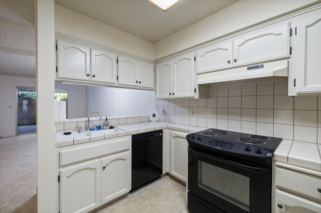 1709 W Calimyrna Ave Unit B, Fresno, CA 93711 - kitchen featuring black appliances, under cabinet range hood, tile countertops, a sink, and tasteful backsplash
