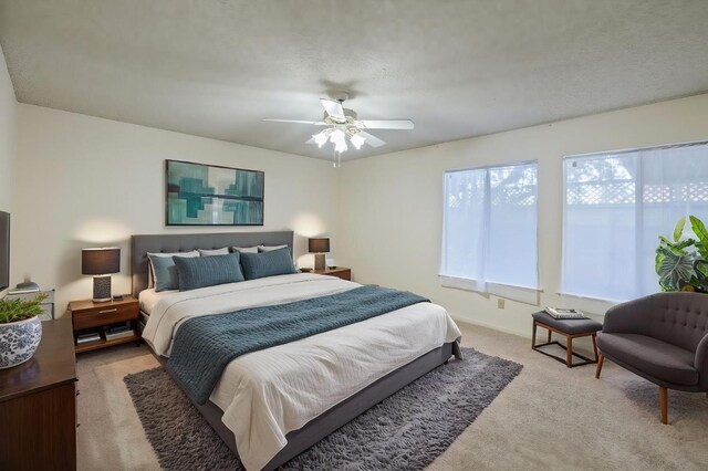 1709 W Calimyrna Ave Unit B, Fresno, CA 93711 - bedroom with light colored carpet, ceiling fan, and baseboards