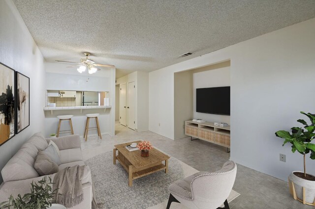 1709 W Calimyrna Ave Unit B, Fresno, CA 93711 - living room with ceiling fan and a textured ceiling