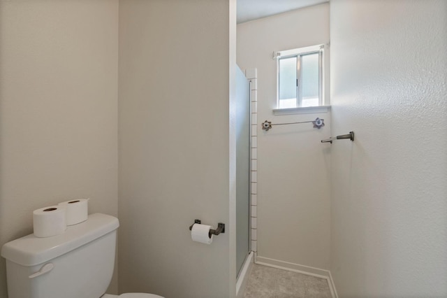 1709 W Calimyrna Ave Unit B, Fresno, CA 93711 - bathroom featuring toilet, a stall shower, and baseboards