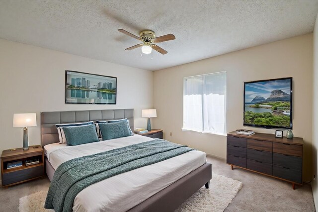 1709 W Calimyrna Ave Unit B, Fresno, CA 93711 - bedroom with light carpet, ceiling fan, and a textured ceiling