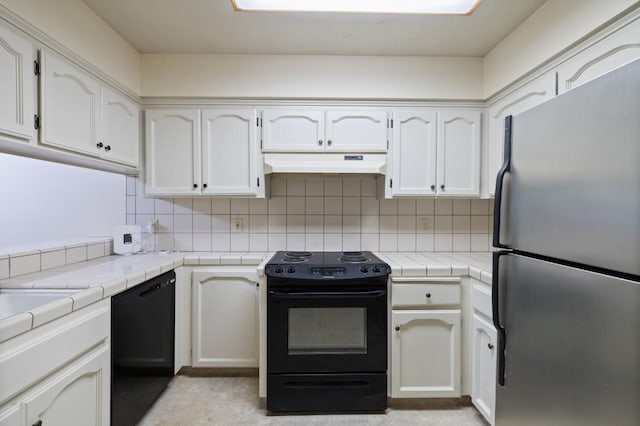 1709 W Calimyrna Ave Unit B, Fresno, CA 93711 - kitchen featuring black appliances, under cabinet range hood, tile countertops, and white cabinetry