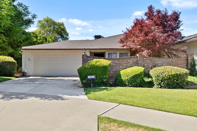 1709 W Calimyrna Ave Unit B, Fresno, CA 93711 - view of front of house featuring driveway, a garage, and board and batten siding