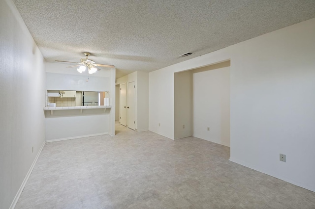 1709 W Calimyrna Ave Unit B, Fresno, CA 93711 - unfurnished living room with ceiling fan, light floors, and a textured ceiling