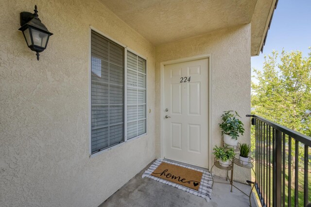 1542 E Alluvial Ave Unit 224, Fresno, CA 93720 - property entrance featuring stucco siding and a balcony