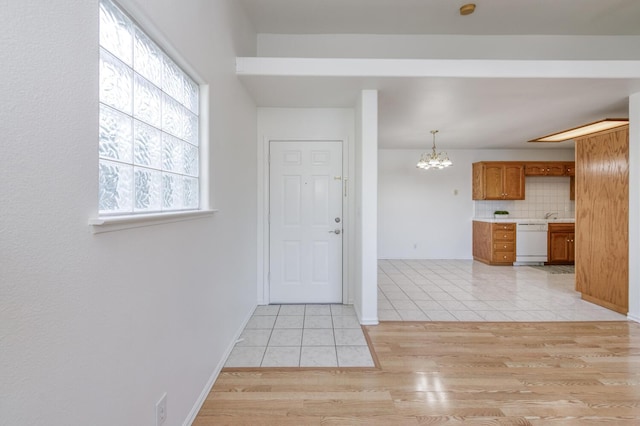 1542 E Alluvial Ave Unit 224, Fresno, CA 93720 - entryway with light tile patterned floors, a chandelier, and baseboards
