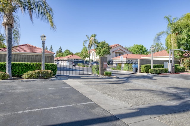 1542 E Alluvial Ave Unit 224, Fresno, CA 93720 - view of asphalt street featuring a gate, street lighting, a gated entry, and curbs