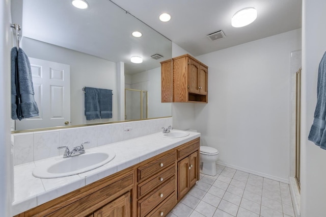 1542 E Alluvial Ave Unit 224, Fresno, CA 93720 - bathroom featuring double vanity, a shower stall, tile patterned flooring, baseboards, and toilet
