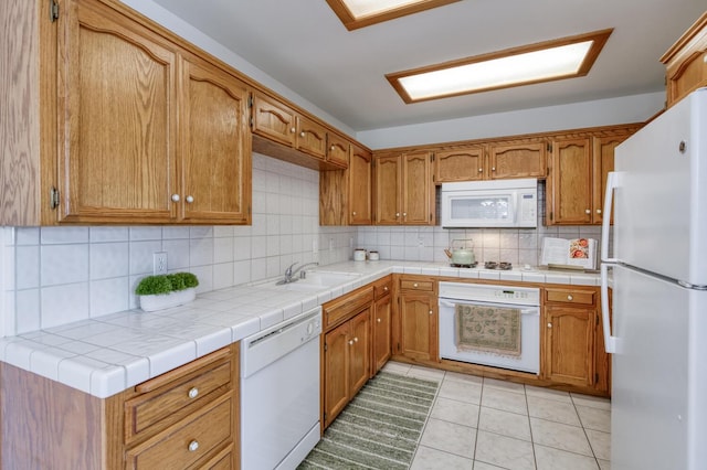 1542 E Alluvial Ave Unit 224, Fresno, CA 93720 - kitchen featuring white appliances, a sink, decorative backsplash, brown cabinets, and light tile patterned floors