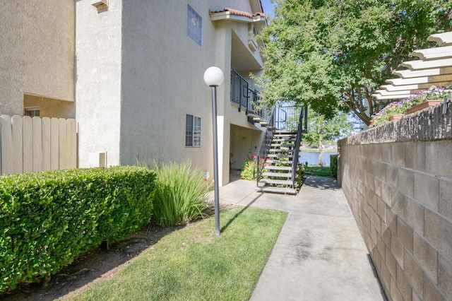 1542 E Alluvial Ave Unit 224, Fresno, CA 93720 - view of property exterior with stucco siding and stairs
