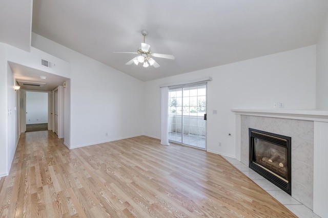 1542 E Alluvial Ave Unit 224, Fresno, CA 93720 - unfurnished living room with light wood-style flooring, vaulted ceiling, a fireplace, a ceiling fan, and baseboards