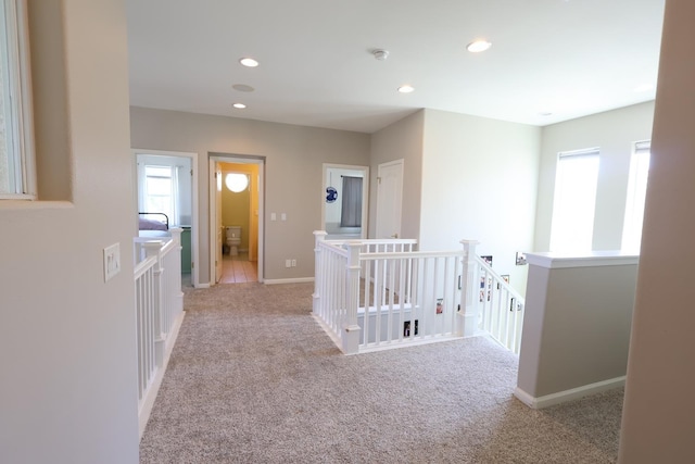 2143 Everglade Ave, Clovis, CA 93619 - hall with an upstairs landing, light carpet, recessed lighting, and baseboards