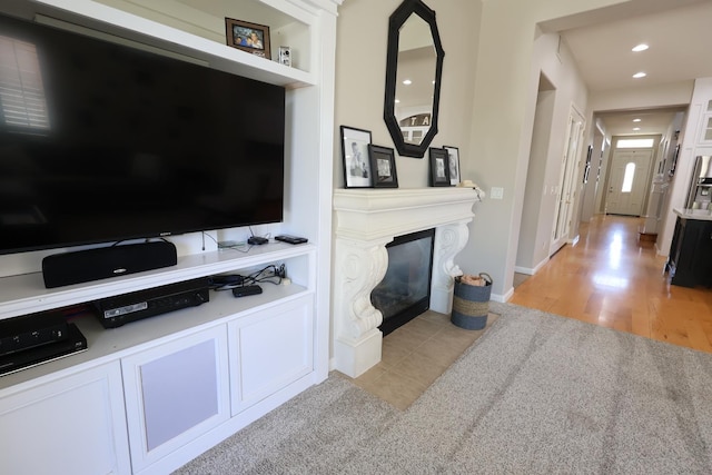 2143 Everglade Ave, Clovis, CA 93619 - living area with a fireplace with flush hearth, light wood-style flooring, and recessed lighting